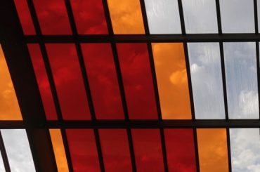 Close up of the word Amsterdam set on the window panes of a bus station roof